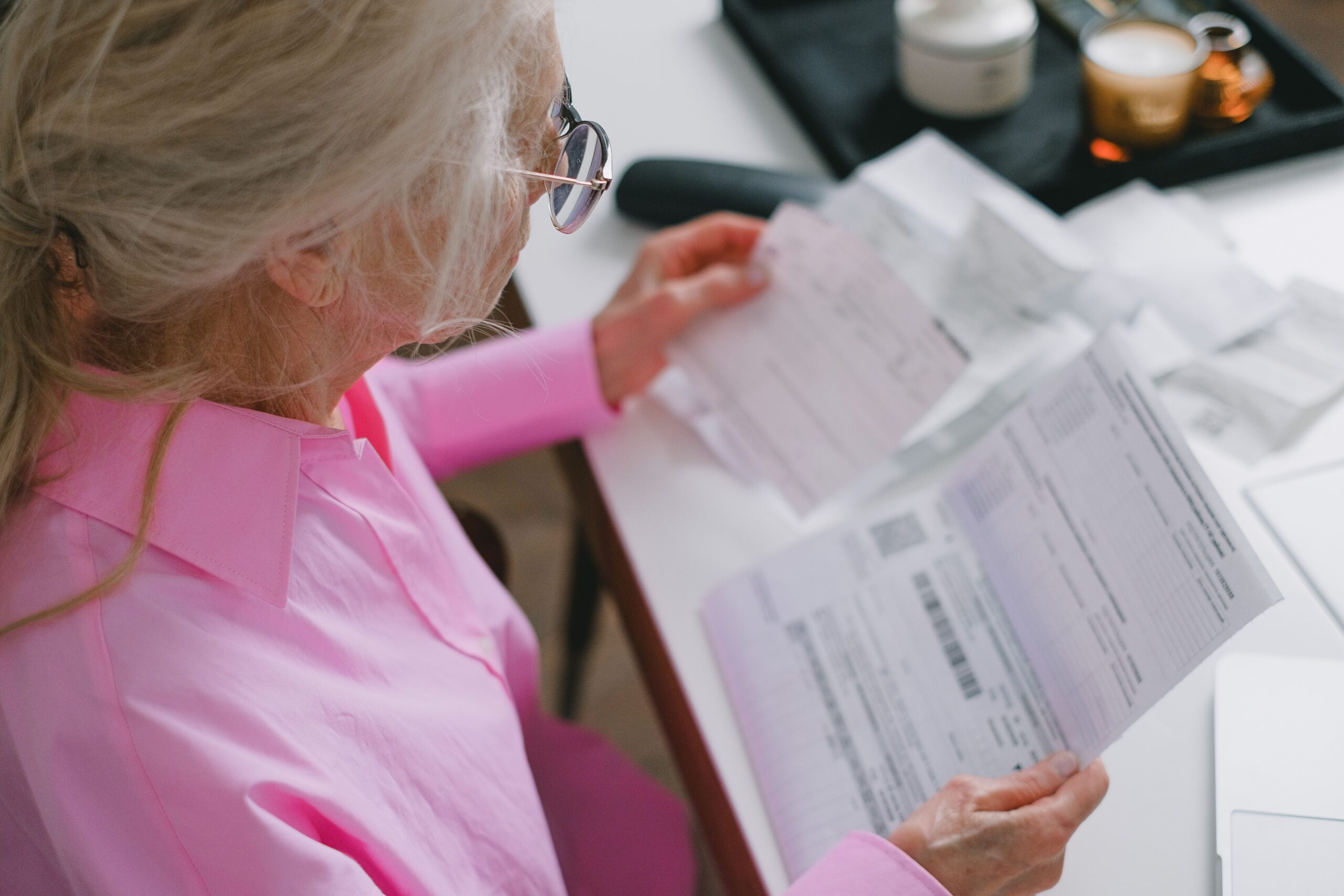 Client reviewing documents for Medicare Entitlement Statement and tax records